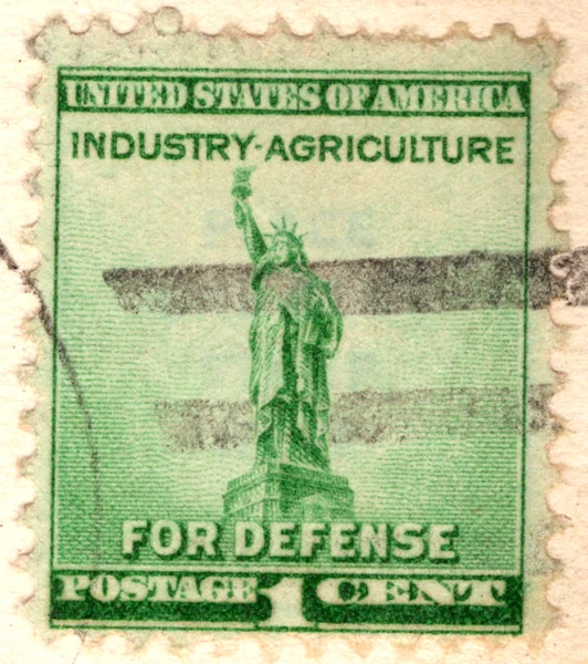 A 1-cent green Statue of Liberty National Defense stamp, reading Industry Agriculture For Defense, on a postcard, from the Postcard Origins collection