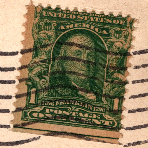 A 1-cent green Benjamin Franklin stamp of the Series of 1902 on a postcard, with a September 1908 postmark, from the Postcard Origins collection