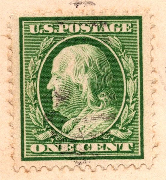 A 1-cent green Benjamin Franklin stamp of the Washington-Franklin series on a postcard, postmarked 1911, from the Postcard Origins collection