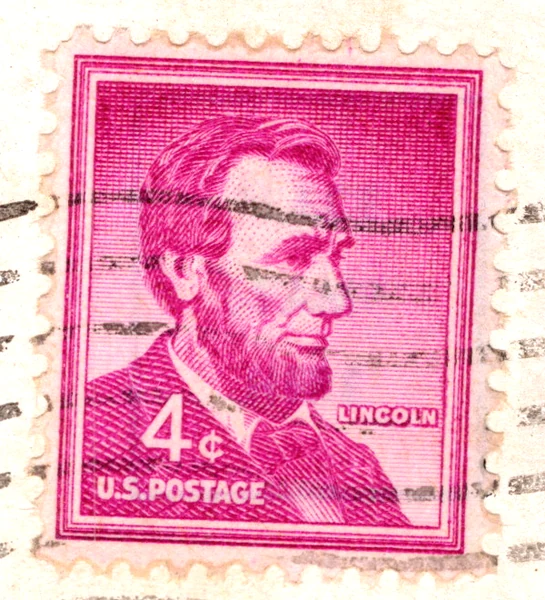 A 4-cent red violet Abraham Lincoln stamp of the Liberty series on a postcard, with a July 1964 postmark, from the Postcard Origins collection