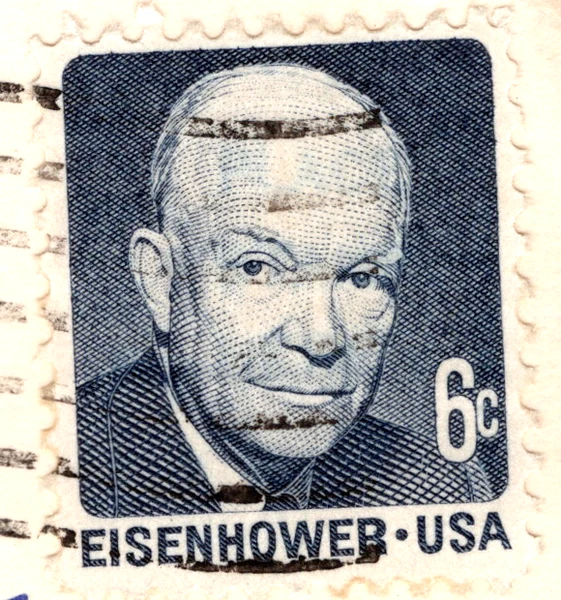 A 6-cent dark blue Dwight D. Eisenhower stamp of the Prominent Americans series on a postcard, from the Postcard Origins collection